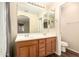 Bright bathroom features a double sink vanity, large mirror and wood-look flooring at 4682 E Redfield Rd, Gilbert, AZ 85234