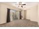 Bright bedroom with carpet flooring, recessed shelving, a ceiling fan and backyard patio access at 4682 E Redfield Rd, Gilbert, AZ 85234