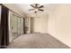 Spacious bedroom featuring carpet flooring, recessed shelving, sliding glass doors, and a ceiling fan at 4682 E Redfield Rd, Gilbert, AZ 85234