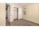 Comfortable bedroom with a carpeted floor, closet, and window at 4682 E Redfield Rd, Gilbert, AZ 85234