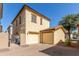 Two car garage with brick paver driveway and desert landscaping enhance this home's curb appeal at 4682 E Redfield Rd, Gilbert, AZ 85234