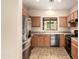 Bright kitchen with oak cabinets, tile flooring, stainless steel appliances, and a window at 4682 E Redfield Rd, Gilbert, AZ 85234