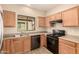 Traditional kitchen with a window over the sink and updated black appliances at 4682 E Redfield Rd, Gilbert, AZ 85234