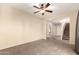 Open-concept living room featuring neutral tones, a ceiling fan, and staircase access at 4682 E Redfield Rd, Gilbert, AZ 85234