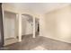 Open-concept living room with neutral walls, carpet flooring, and multiple archways for seamless flow at 4682 E Redfield Rd, Gilbert, AZ 85234