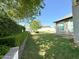 Spacious backyard with green grass, hedges, and mature trees at 4824 S Brice --, Mesa, AZ 85212