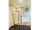 Modern bathroom with a glass-enclosed shower, separate bathtub, and stylish chandelier lighting at 4824 S Brice --, Mesa, AZ 85212