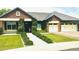 Charming brick home with a well-manicured lawn, lush greenery, and a three-car garage at 4824 S Brice --, Mesa, AZ 85212
