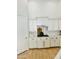 Bright, white kitchen with subway tile, white cabinets, stainless steel appliances, and hardwood floors at 4824 S Brice --, Mesa, AZ 85212