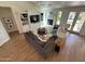 Spacious living room with fireplace, hardwood floors, ceiling fan, neutral decor and built in bookcase at 4824 S Brice --, Mesa, AZ 85212