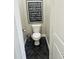 Compact powder room featuring dark herringbone tile flooring and a modern toilet and decorative trash can at 4824 S Brice --, Mesa, AZ 85212