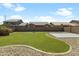 Well-maintained backyard featuring a lush lawn, desert landscaping and a concrete pad, perfect for outdoor enjoyment at 4933 W Melody Ln, Laveen, AZ 85339