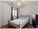 Bedroom featuring a window and neutral walls, and a ceiling fan with a light fixture at 4933 W Melody Ln, Laveen, AZ 85339
