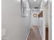 Well-lit hallway with wood floors and neutral walls leading to various rooms in the home at 4933 W Melody Ln, Laveen, AZ 85339