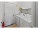 Functional laundry room equipped with a washer, dryer, and shelving for storage solutions at 4933 W Melody Ln, Laveen, AZ 85339