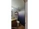 Bathroom with a granite counter top, shelves, and blue decorative shower curtain at 5539 E Dragoon Ave, Mesa, AZ 85206