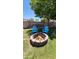 Backyard fire pit with brick surround and two blue Adirondack chairs perfect for outdoor entertaining at 5539 E Dragoon Ave, Mesa, AZ 85206