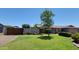 Lovely home with a tree-lined front yard and a well-maintained lawn, complemented by blue skies at 5539 E Dragoon Ave, Mesa, AZ 85206