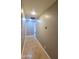 Well lit hallway with tile flooring, neutral paint color, and modern thermostat at 5539 E Dragoon Ave, Mesa, AZ 85206