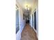 Inviting hallway featuring tiled flooring, decorative lighting, and doorways leading to various rooms at 5539 E Dragoon Ave, Mesa, AZ 85206