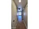 Hallway with tile flooring and natural light leads to the backyard through double doors at 5539 E Dragoon Ave, Mesa, AZ 85206