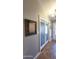 Hallway features decorative glass doors, tile floors, and wainscoting, adding architectural details to the space at 5539 E Dragoon Ave, Mesa, AZ 85206