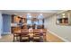 Bright and open kitchen with granite countertops, wood cabinets, and a large dining table for Gathering gatherings at 5539 E Dragoon Ave, Mesa, AZ 85206