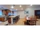 Open-concept kitchen and dining area, showcasing a large island and stylish wooden dining set at 5539 E Dragoon Ave, Mesa, AZ 85206