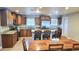 Well-lit kitchen featuring granite countertops, wooden cabinets, and a cozy dining area with modern lighting at 5539 E Dragoon Ave, Mesa, AZ 85206