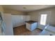 Spacious laundry room with plenty of storage cabinets, a folding table, and modern washer and dryer appliances at 5539 E Dragoon Ave, Mesa, AZ 85206