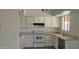 Functional kitchen featuring white cabinets, appliances, and lots of natural light at 5916 W Pierce St, Phoenix, AZ 85043