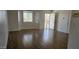 Bright living room with hardwood floors, a bay window, and a secure front door at 5916 W Pierce St, Phoenix, AZ 85043
