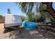 Large backyard with trees, a trailer and a car covered with a blue tarp at 6249 E Larkspur Dr, Scottsdale, AZ 85254