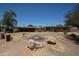 View of the backyard showcasing rock features, sparse vegetation, and the home's exterior at 6249 E Larkspur Dr, Scottsdale, AZ 85254