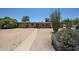 Charming single-story brick home featuring a spacious front yard and mature desert landscaping at 6249 E Larkspur Dr, Scottsdale, AZ 85254