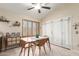 Bright dining room with shuttered window and sliding door access to backyard at 6319 W Mercer Ln, Glendale, AZ 85304