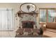 Living room fireplace with a stone surround, hearth, and mantle at 6319 W Mercer Ln, Glendale, AZ 85304