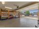 Well-organized garage with shelving, storage, and an open garage door at 6319 W Mercer Ln, Glendale, AZ 85304