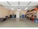 Spacious garage with epoxy floors, storage shelves, and access to the house at 6319 W Mercer Ln, Glendale, AZ 85304