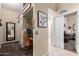 Hallway nook with desk and chair adjacent to carpeted living area at 6319 W Mercer Ln, Glendale, AZ 85304