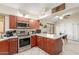 View from kitchen to dining area with stainless steel appliances and countertops at 6319 W Mercer Ln, Glendale, AZ 85304