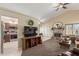 Inviting living room featuring a stone fireplace, carpet floors, and ample space at 6319 W Mercer Ln, Glendale, AZ 85304