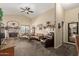 Spacious living room boasting high ceilings, carpet floors, and a stone fireplace at 6319 W Mercer Ln, Glendale, AZ 85304
