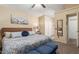 Comfortable main bedroom with a ceiling fan, carpeted floors and ensuite bathroom access at 6319 W Mercer Ln, Glendale, AZ 85304