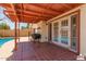 Covered patio features tile flooring, BBQ, and views of the pool at 6319 W Mercer Ln, Glendale, AZ 85304