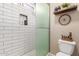 Modern shower with white subway tile surround, built-in niche and glass door at 6319 W Mercer Ln, Glendale, AZ 85304