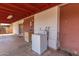 A covered back porch area with brick detailing that includes laundry hookups at 6521 W Flower St, Phoenix, AZ 85033