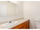 A clean bathroom with white sink and vanity, and toilet at 6521 W Flower St, Phoenix, AZ 85033