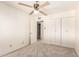 Inviting bedroom featuring soft carpet, a ceiling fan, and neutral tones throughout the space at 6521 W Flower St, Phoenix, AZ 85033