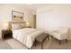 Peaceful bedroom with neutral decor, featuring ample closet space and soft lighting for a comfortable and restful environment at 6521 W Flower St, Phoenix, AZ 85033